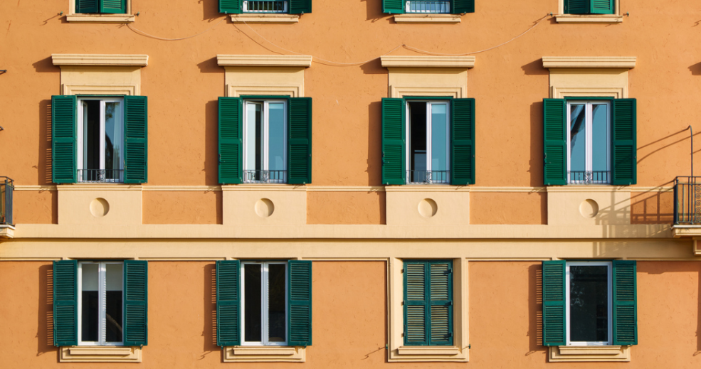 Yellow building with green shutters