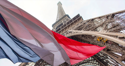 French flag in front of the Eiffel Tower